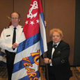 P/D/C Ken Danley and D/C Millie Steffe with D30 100th anniversary Ensign